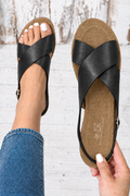 Sandalias negras de tiras cruzadas, vista superior y puesta en el pie